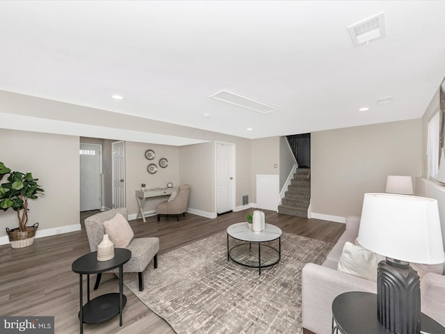 living room with baseboards, visible vents, stairway, wood finished floors, and recessed lighting