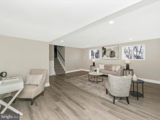 living area with baseboards, stairway, wood finished floors, and recessed lighting