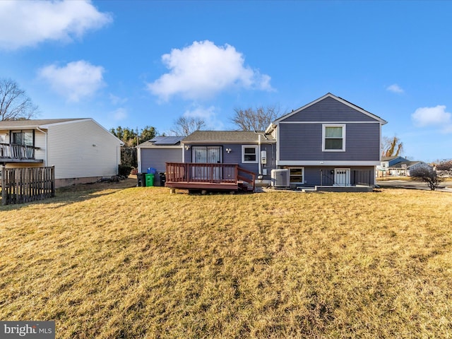 back of house featuring a yard, a deck, and central AC unit