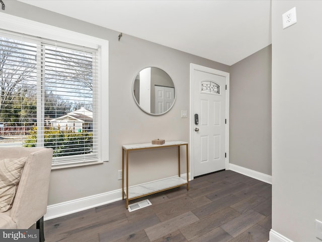 entryway featuring dark wood-type flooring, visible vents, and baseboards