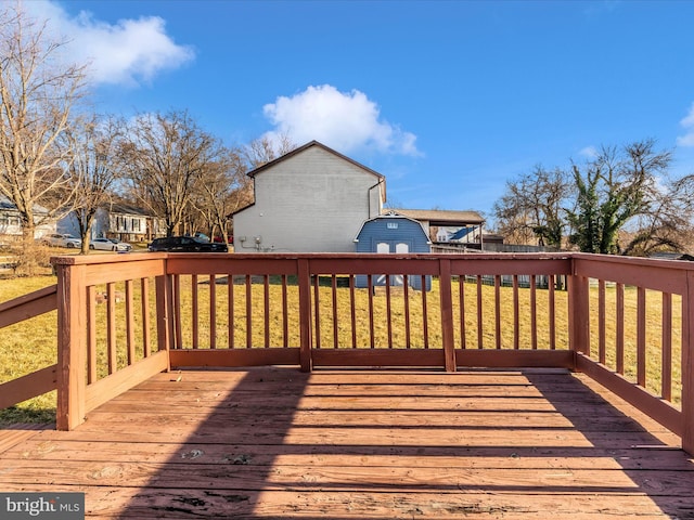 wooden terrace featuring a yard