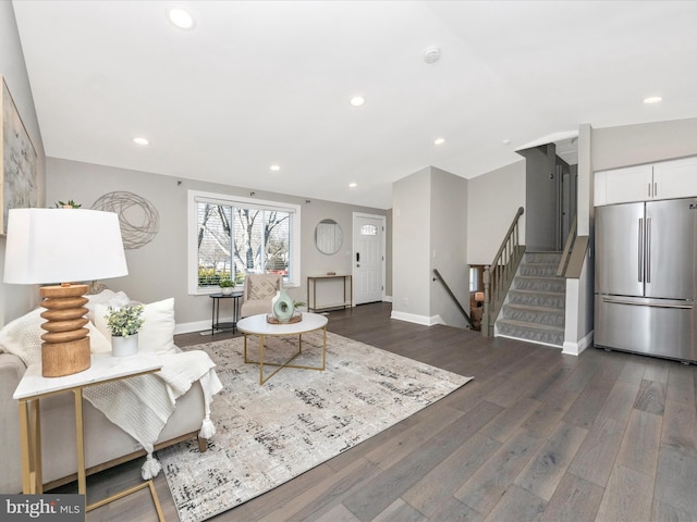 living room featuring dark wood-type flooring, recessed lighting, stairway, and baseboards