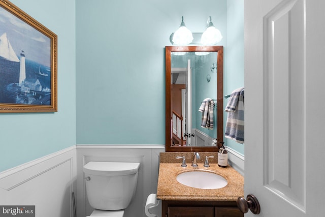 bathroom featuring vanity and toilet