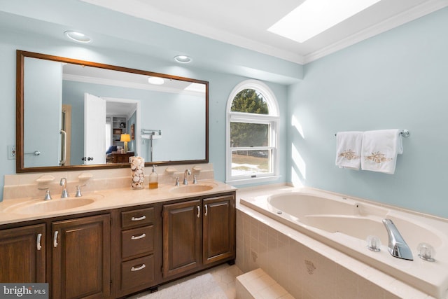 bathroom with crown molding, vanity, tiled bath, and a skylight