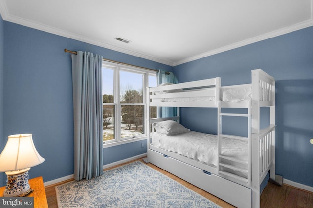 bedroom featuring crown molding and hardwood / wood-style flooring