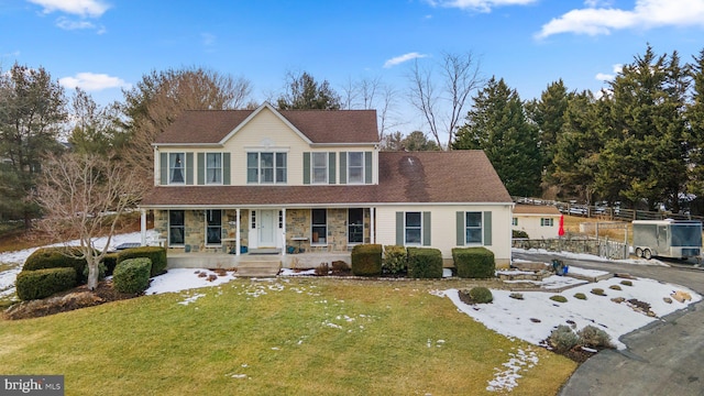 view of front of house with a porch and a front lawn