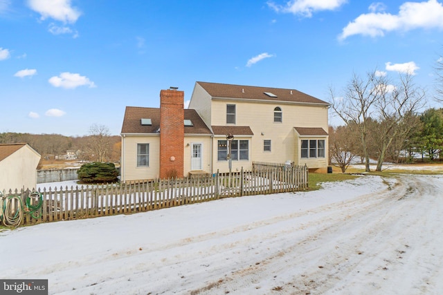 view of snow covered rear of property