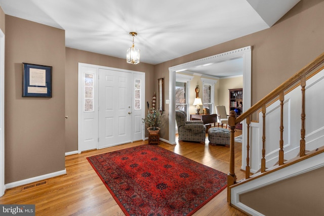 foyer featuring a notable chandelier and light wood-type flooring