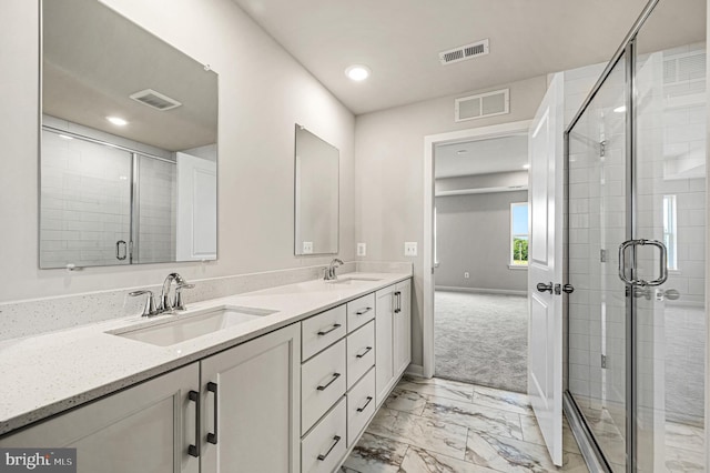 bathroom featuring vanity and an enclosed shower