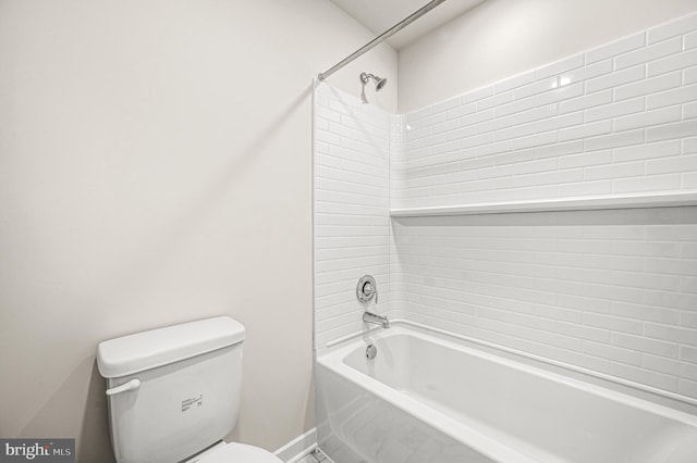 bathroom featuring toilet and tiled shower / bath