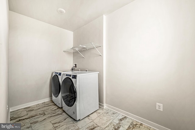 clothes washing area featuring washer and clothes dryer