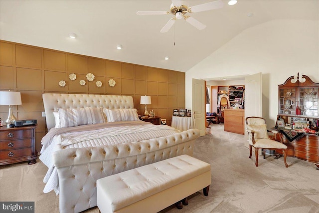 carpeted bedroom with lofted ceiling, ceiling fan, and tile walls