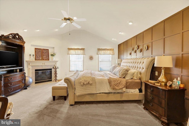 bedroom featuring ceiling fan, light colored carpet, a fireplace, and high vaulted ceiling