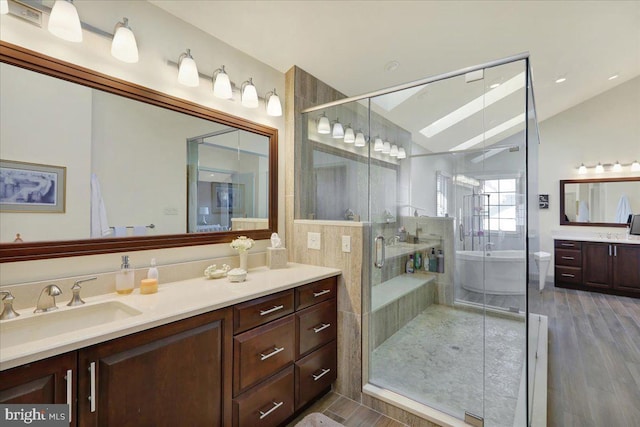 bathroom featuring lofted ceiling, vanity, a shower with shower door, and wood-type flooring