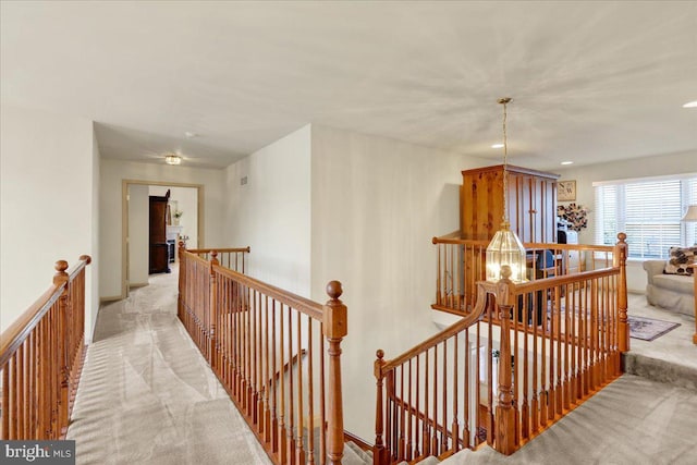 hallway featuring light colored carpet