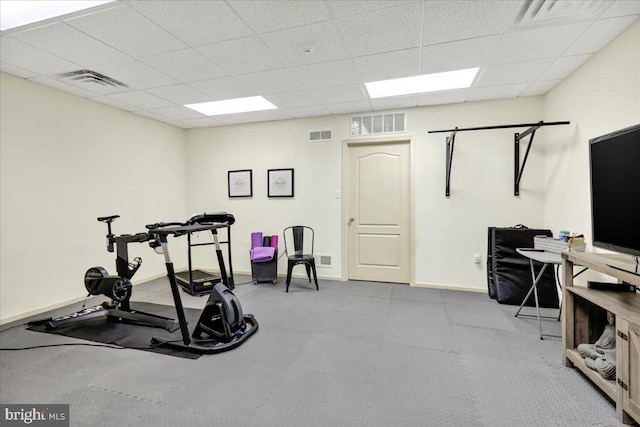 exercise room with a paneled ceiling