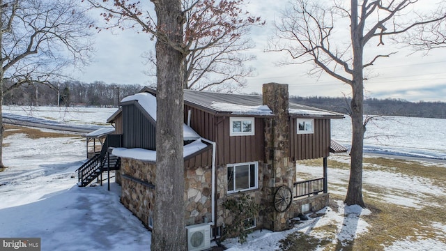 view of snowy exterior featuring ac unit