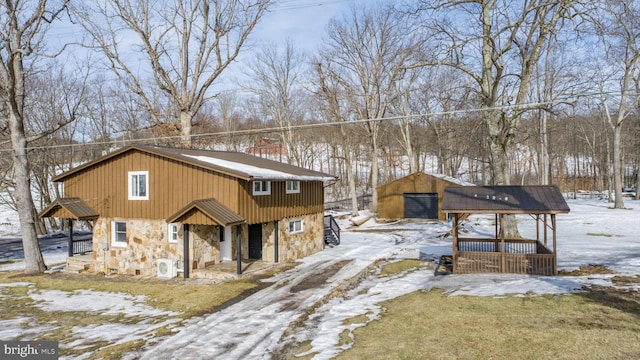 view of front of property with a garage and an outdoor structure