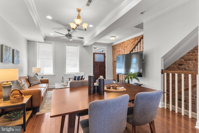 dining area with ornamental molding, brick wall, dark hardwood / wood-style floors, and ceiling fan