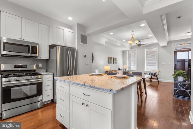 kitchen featuring dark wood-type flooring, appliances with stainless steel finishes, and white cabinets