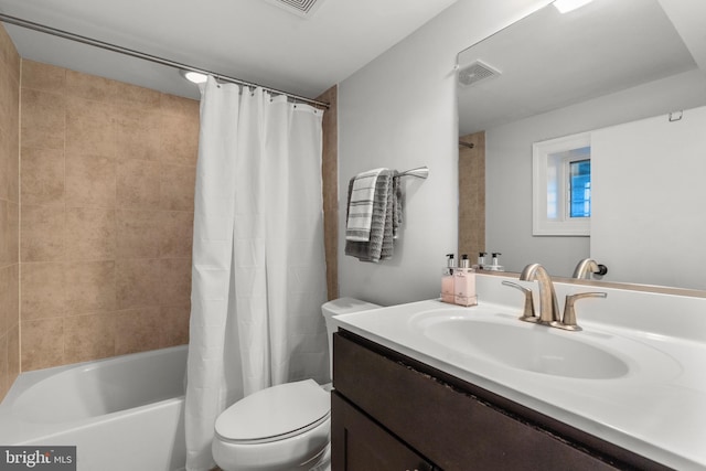 full bathroom featuring toilet, vanity, and shower / bathtub combination with curtain