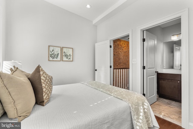 bedroom featuring wood-type flooring and ensuite bathroom