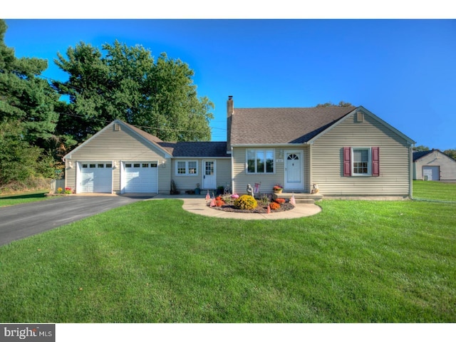 view of front of property with a garage and a front lawn