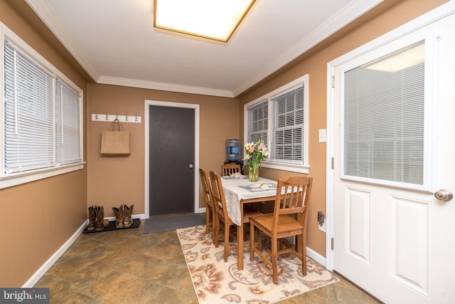 dining space featuring crown molding