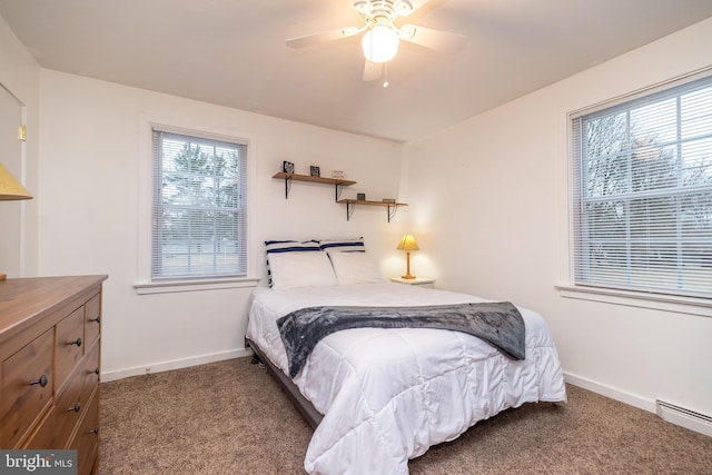 carpeted bedroom featuring ceiling fan and a baseboard heating unit