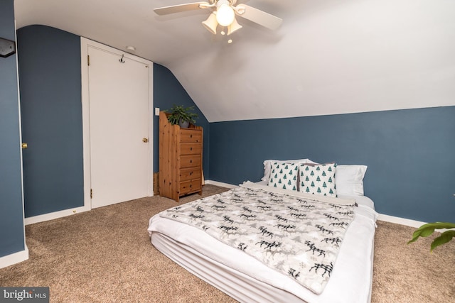 bedroom with ceiling fan, lofted ceiling, and carpet