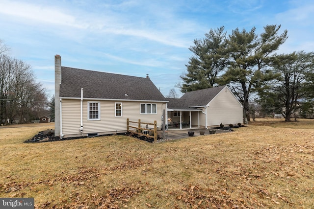 back of house with a yard and a patio area