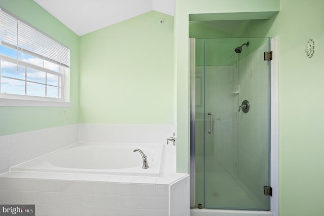 bathroom with lofted ceiling and separate shower and tub