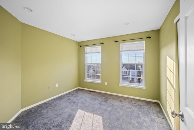 spare room featuring light colored carpet