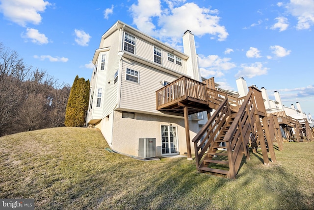 back of property featuring a wooden deck, a yard, and central air condition unit