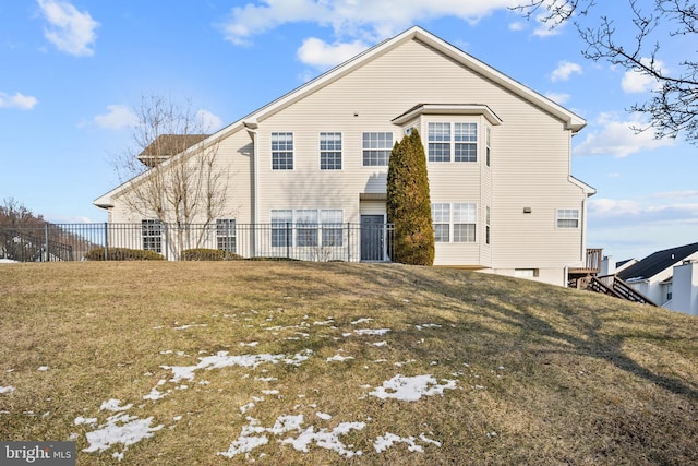 rear view of house with a yard