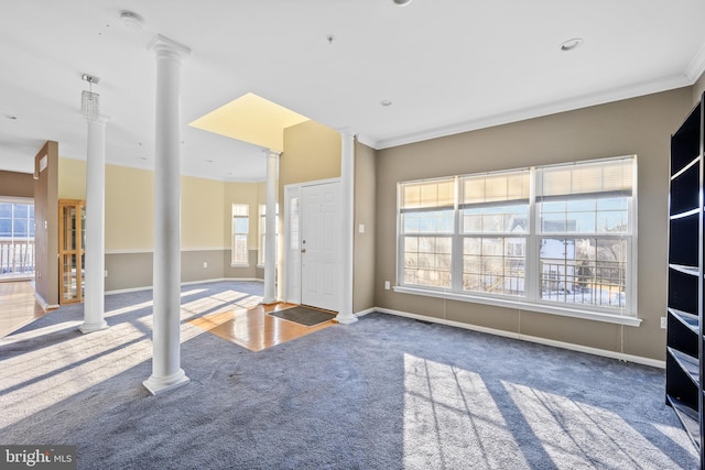 interior space featuring crown molding and decorative columns