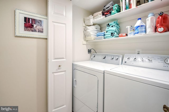 clothes washing area with separate washer and dryer