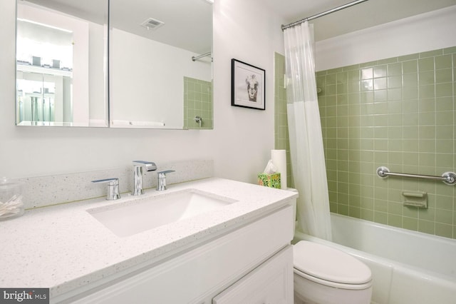 full bathroom with vanity, toilet, and shower / bath combo with shower curtain