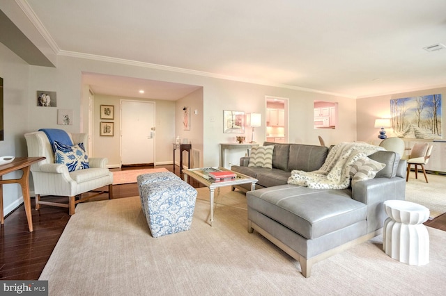 living room featuring wood-type flooring and ornamental molding