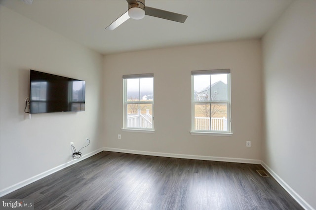 unfurnished living room featuring ceiling fan and dark hardwood / wood-style flooring