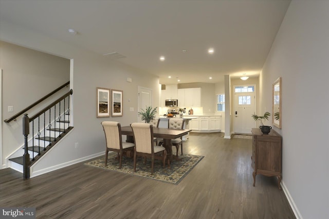 dining area featuring dark wood-type flooring