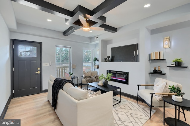 living room with ceiling fan, coffered ceiling, beam ceiling, and light hardwood / wood-style flooring