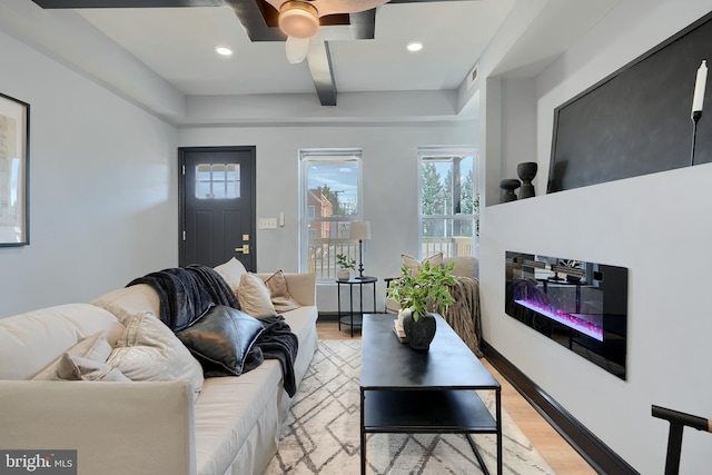 living room with ceiling fan and light hardwood / wood-style floors