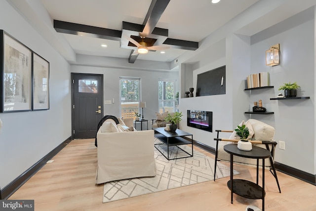 living room featuring ceiling fan, coffered ceiling, beam ceiling, and light hardwood / wood-style flooring