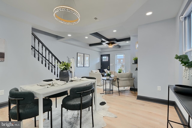 dining area featuring beam ceiling, coffered ceiling, and light wood-type flooring