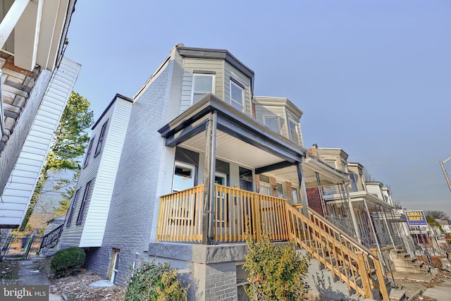 townhome / multi-family property featuring covered porch