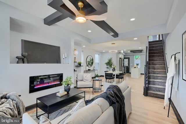 living room featuring beam ceiling, ceiling fan, and light hardwood / wood-style flooring