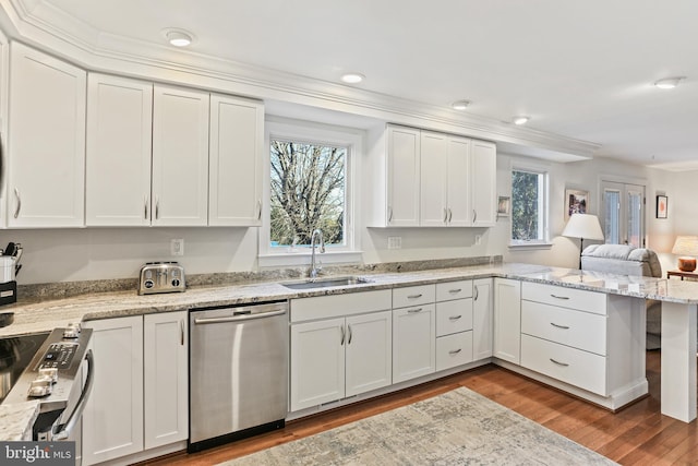 kitchen featuring sink, white cabinets, and appliances with stainless steel finishes