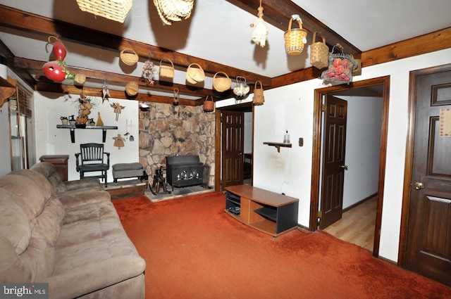 living room featuring beamed ceiling and light carpet