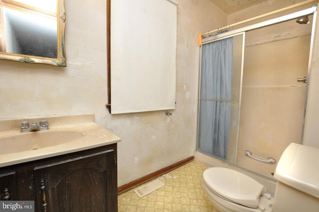 bathroom with vanity, toilet, and an enclosed shower